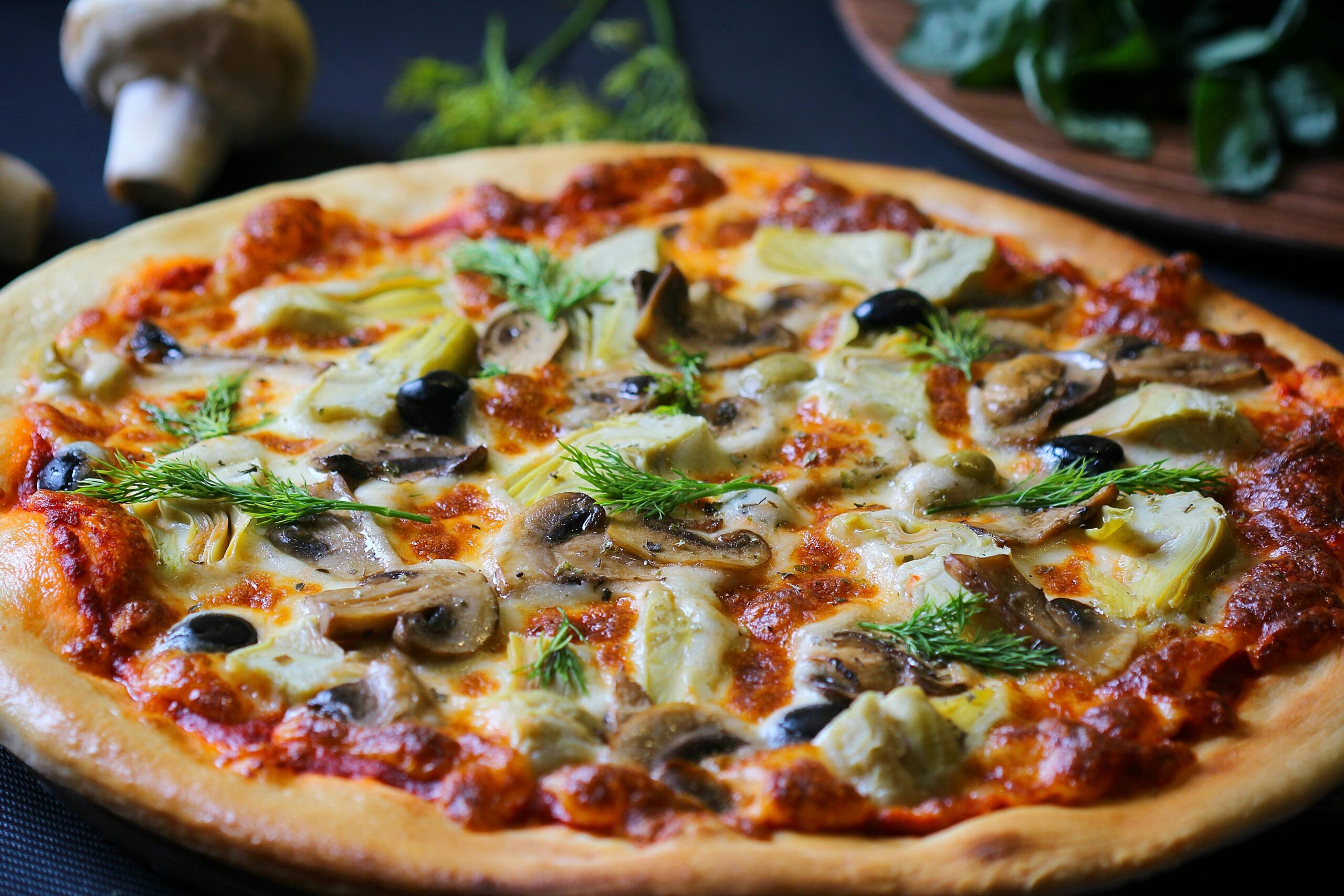 Close-up of a freshly baked vegetarian pizza with mushrooms, olives, and herbs perfect for food lovers.